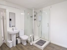 A bathroom with shower, sink, and toilet at Plas Yn Bonwm in Corwen