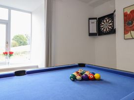 A game room with a pool table and a dartboard at Plas Yn Bonwm Corwen