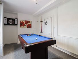 A room with a pool table and dartboard at Plas Yn Bonwm in Corwen