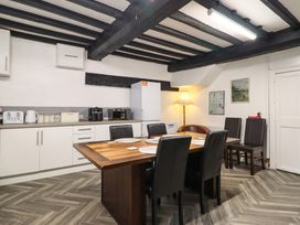 A kitchen with a table and chairs at Plas Yn Bonwm in Corwen