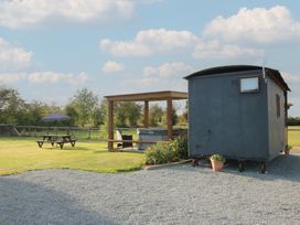 A shepherd hut and outdoor seating area at Sharon's Shepherd Hut Oswestry