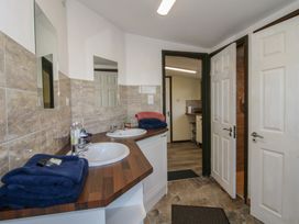 A bathroom with dual sinks and towels on the counter at Sharon's Shepherd Hut in Oswestry