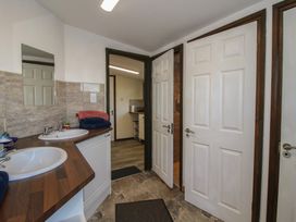 A bathroom with double sinks and a mirror at Sharon's Shepherd Hut Oswestry