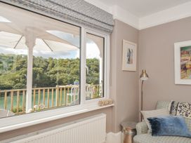 A living room with a view of the river at Mayhurst in Looe