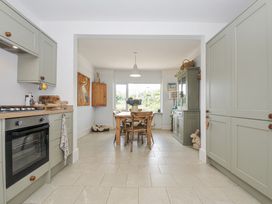 A kitchen with a table and chairs at Mayhurst in Looe