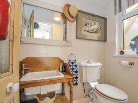 A bathroom with a sink and toilet at Mayhurst in Looe