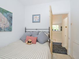 A bedroom with a bed and artwork at Mayhurst in Looe
