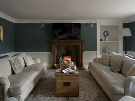 A living room with sofas and a coffee table at Holwell Farmhouse in Bampton