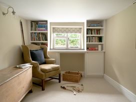 A study with a desk and bookshelves at Holwell Farmhouse in Bampton