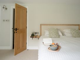 A bedroom with a bed and a bedside table at Holwell Farmhouse in Bampton