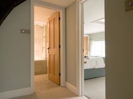 A hallway with doors leading to a bathroom and a bedroom at Holwell Farmhouse in Bampton