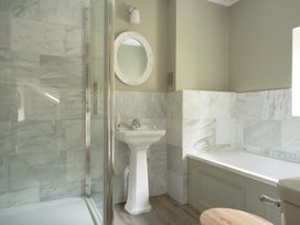 A bathroom with a shower, sink, and bathtub at Holwell Farmhouse in Bampton