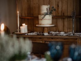 A dining room with a cake and candles at Holwell Farmhouse in Bampton