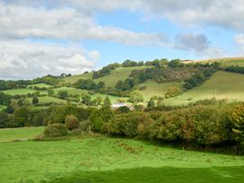 A countryside view with hills and trees at Holwell Farmhouse in Bampton