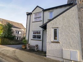 A house exterior with a bench and plants at 11 Tram Lane Kirkby Lonsdale