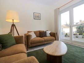 A living room with a lamp and sofas at 11 Tram Lane, Kirkby Lonsdale