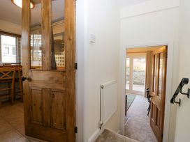 A hallway with a door and staircase at 11 Tram Lane Kirkby Lonsdale