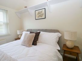 A bedroom with a bed and wall decor at 11 Tram Lane in Kirkby Lonsdale