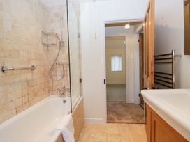 A bathroom with a bathtub and shower at 11 Tram Lane in Kirkby Lonsdale