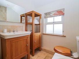 A bathroom with sink, toilet, and towel rack at 11 Tram Lane in Kirkby Lonsdale