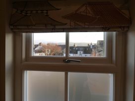 A window with a view of houses and a tree at 11 Tram Lane in Kirkby Lonsdale