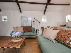 A living room with a sofa and coffee table at Garreg Fawr