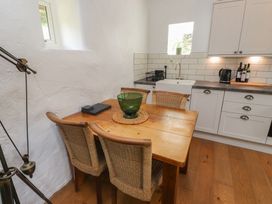 A kitchen with a dining table and chairs at Garreg Fawr