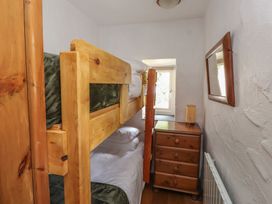 A bedroom with bunk bed and nightstand at Garreg Fawr