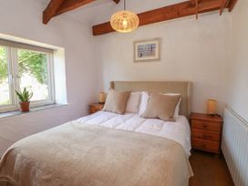 A bedroom with a bed and window at Garreg Fawr 