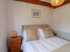 A bedroom with a bed and bedside table at Garreg Fawr