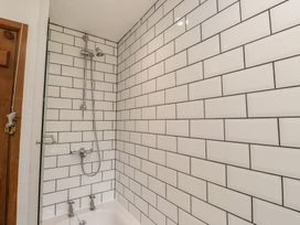 A bathroom with a shower and bathtub at Garreg Fawr