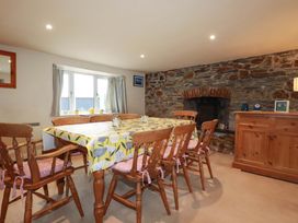 A dining room with a table and chairs at Rosewin Farmhouse near St Minver