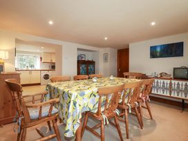 A dining room with a table and chairs at Rosewin Farmhouse near St Minver