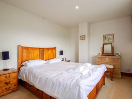 A bedroom with a bed and dresser at Rosewin Farmhouse near St Minver