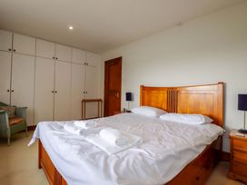 A bedroom with a bed and wardrobe at Rosewin Farmhouse near St Minver
