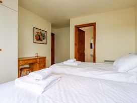 A bedroom with twin beds and a chest of drawers at Rosewin Farmhouse near St Minver