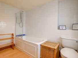 A bathroom with a bathtub and shower at Rosewin Farmhouse near St Minver