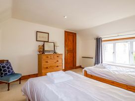 A bedroom with two beds and a dresser at Rosewin Farmhouse near St Minver