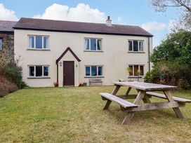 A house with a picnic table in the garden at Rosewin Farmhouse near St Minver