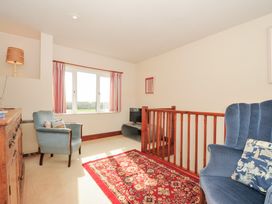 A living room with sofa and television at Rosewin Farmhouse near St Minver