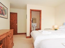A bedroom with two beds and a washbasin at Rosewin Farmhouse near St Minver
