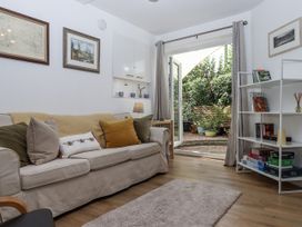 A living room with a sofa and shelving at The Workshop in Mary Tavy