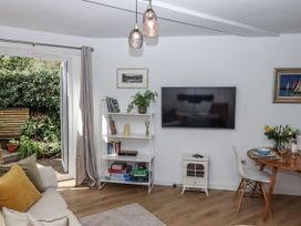 A living room with a sofa and television at The Workshop in Mary Tavy