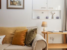 A living room with a sofa and decorative items at The Workshop in Mary Tavy