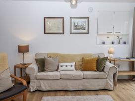 A living room with a sofa and lamp at The Workshop in Mary Tavy