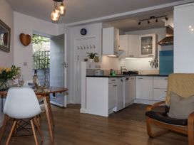 A kitchen with dining area and open door at The Workshop in Mary Tavy