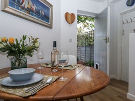 A dining room with a round table set for two at The Workshop in Mary Tavy