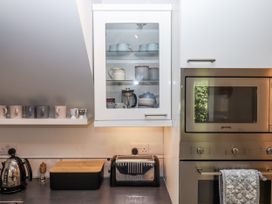 A kitchen with cabinets and appliances at The Workshop in Mary Tavy