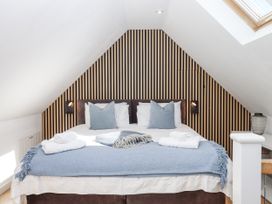 A bedroom with a bed and lamps at The Workshop in Mary Tavy