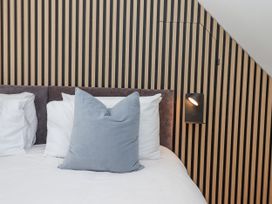A bedroom with a bed and decorative pillows at The Workshop in Mary Tavy